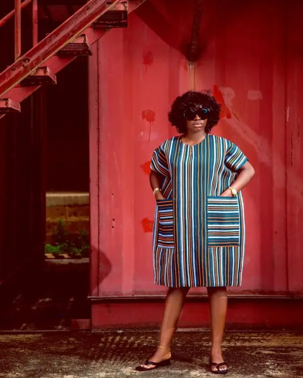 lady wearing a dress made from Aso oke